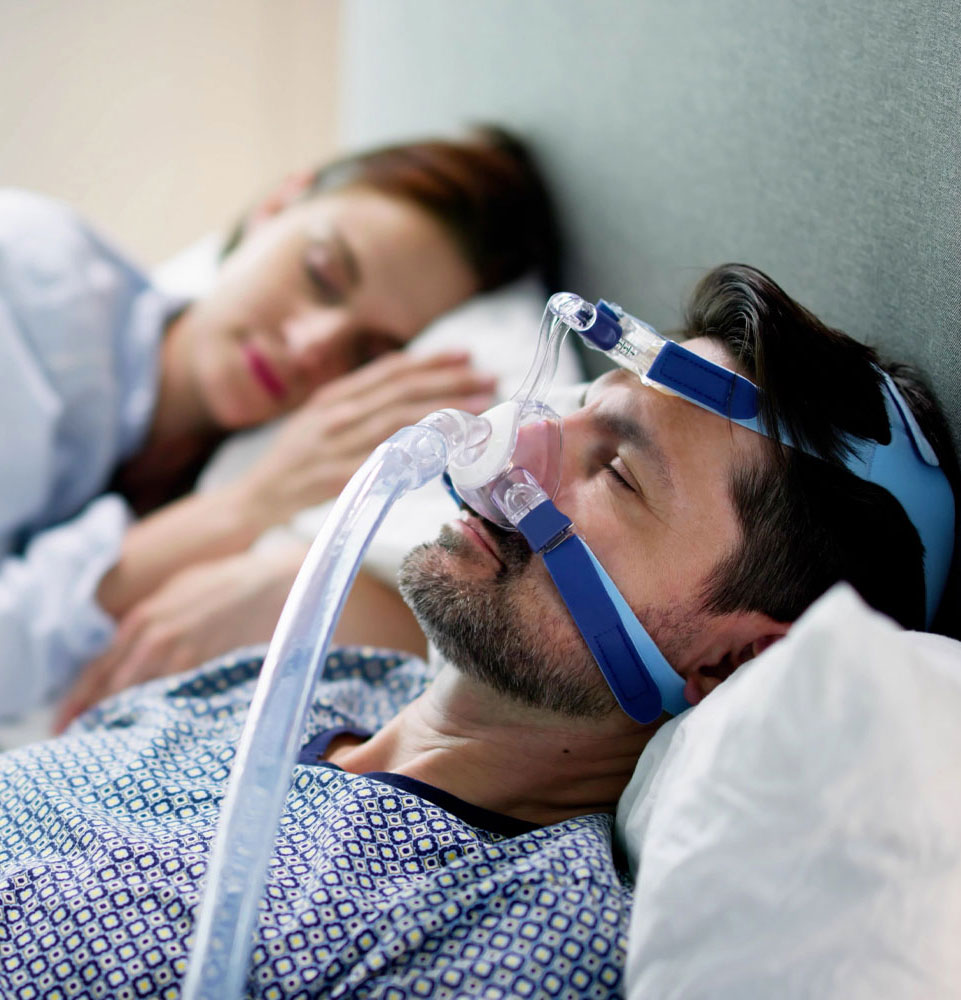 man with cpap machine suffering from sleep apnea