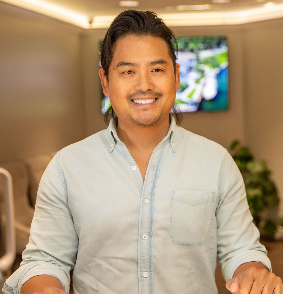 david with new smile at desk
